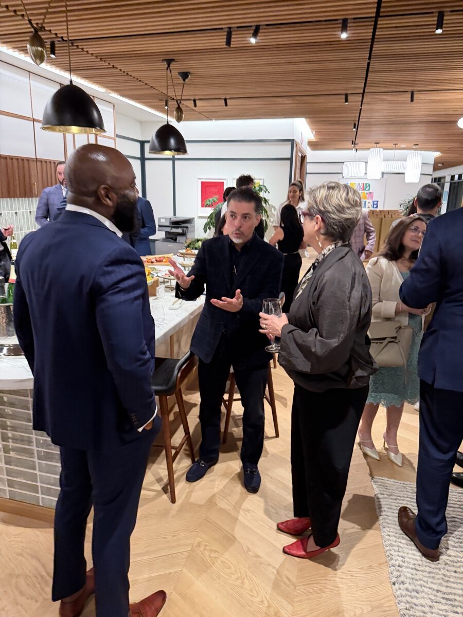 Three guests in conversation during a private gathering at PushFire.