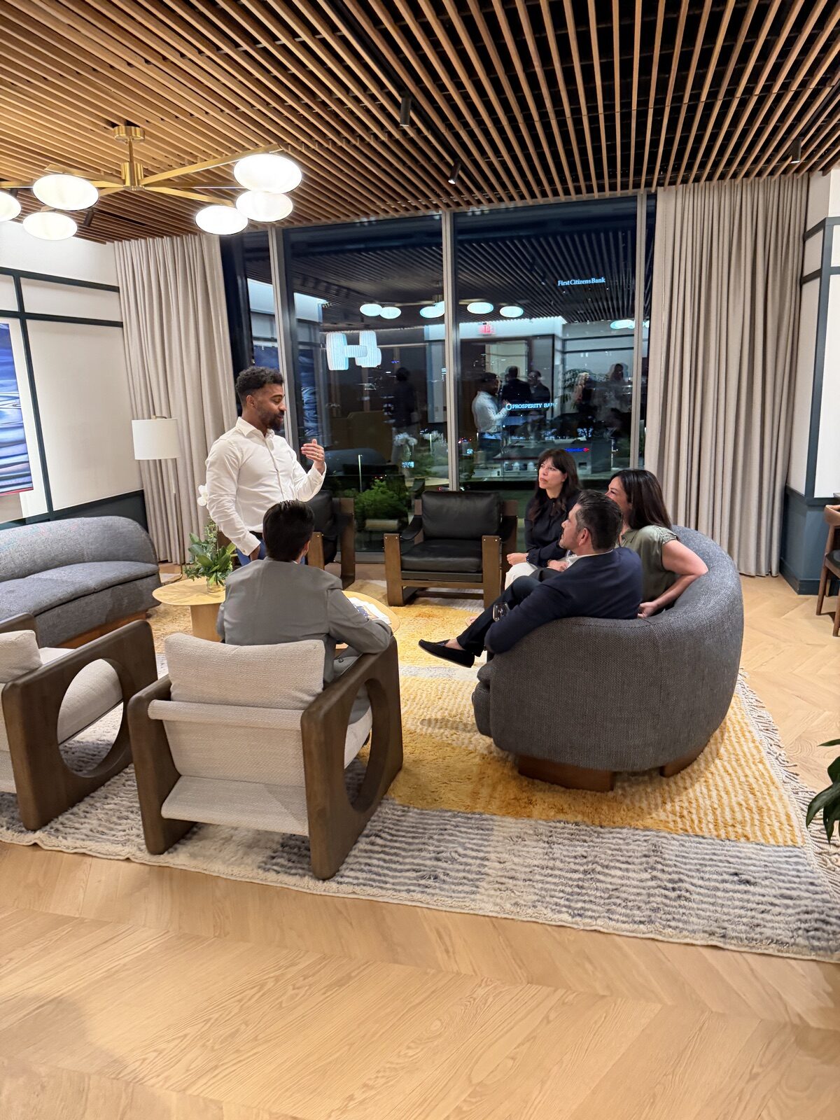 Small group listening to a speaker during a private gathering at the PushFire office.